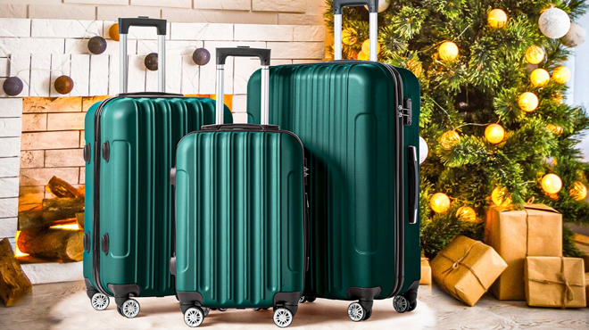 Zimtown 3 Piece Spinner Suitcase beside a Christmas Tree