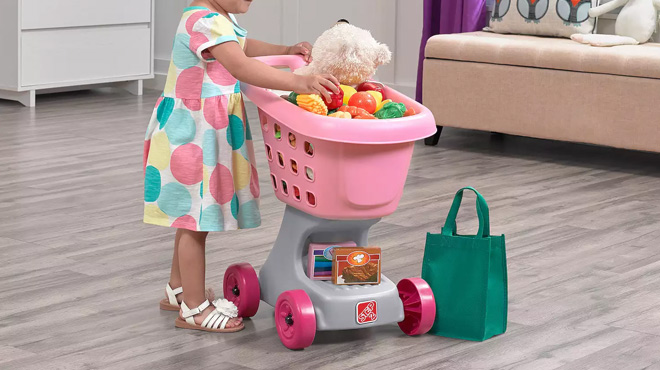 a Kid Playing with Step2 Shopping Cart