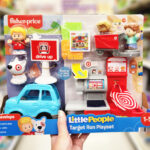 a Person Holding Fisher Price Little People Target Run Playset