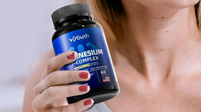 a Person Holding Magnesium Glycinate Supplement 60 Count Bottle