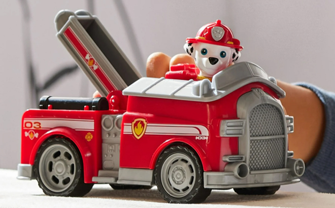 A Boy Playing with the Paw Patrol Marshall's Firetruck with Figure