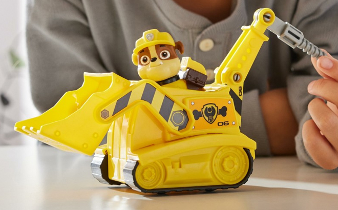 A Boy Playing with the Paw Patrol Rubble’s Bulldozer Vehicle with Figure