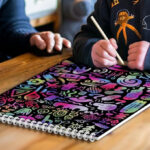 A Child Drawing on the Rainbow Scratch Paper