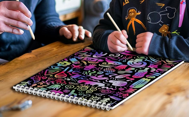 A Child Drawing on the Rainbow Scratch Paper