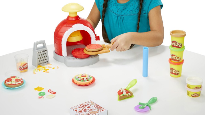 A Girl Playing with Play Doh Kitchen Creations Pizza Oven Playset