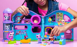 A Girl Playing with the Littlest Pet Shop Deluxe Playset