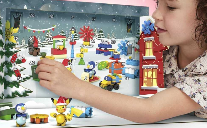 A Girl Playing with the Mega Pokemon 202 Piece Holiday Calendar Building Toy Set