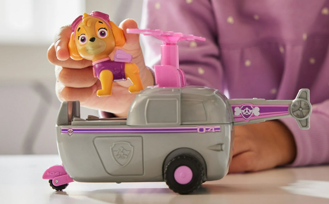 A Girl Playing with the Paw Patrol Skye’s Helicopter Vehicle with Figure