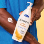 A Hand holding Jergens Ultra Healing Dry Skin Lotion