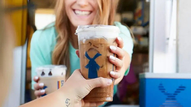 A Hand holding a Dutch Bros Drink