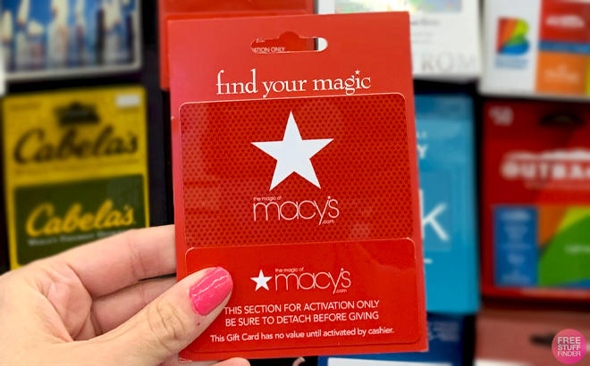 A Hand holding a Macys Gift Card