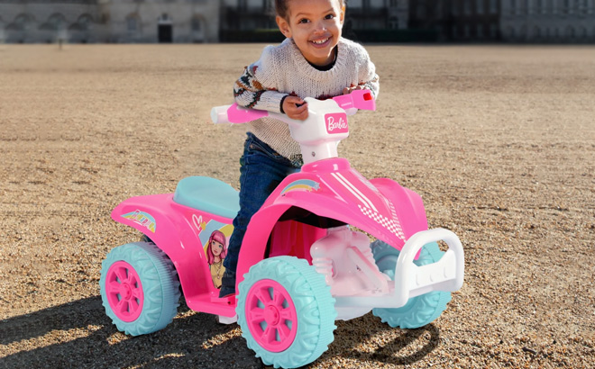 A Kid is Sitting on Barbie Powered Ride On