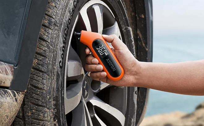 A Man Using the AstroAI Digital Tire Pressure Gauge