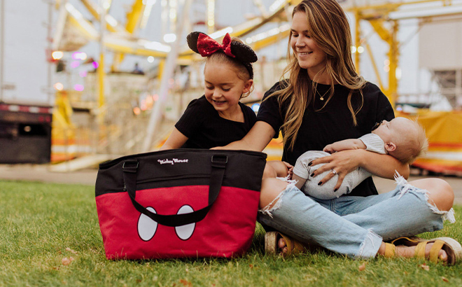 A Mom and Little Girl Using the Picnic Time Disney Mickey Mouse Topanga Tote Cooler Bag