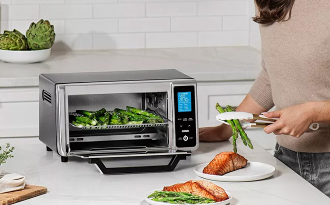 A Person Cooking Using a Gourmia 4 Slice Toaster Oven Air Fryer