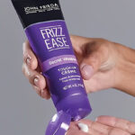 A Person Holding John Frieda Frizz Ease Secret Weapon Touch Up Creme