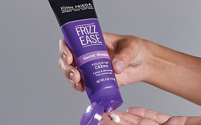 A Person Holding John Frieda Frizz Ease Secret Weapon Touch Up Creme