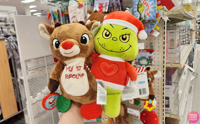 A Person Holding Rudolph Grinch Toys