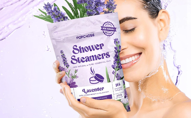 A Person Holding a 16 Count bag of the Shower Steamers Aromatherapy Tablets