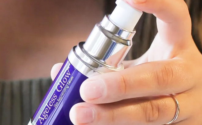 A Person Holding a Bottle of BioTrust Ageless Glow Skin Serum