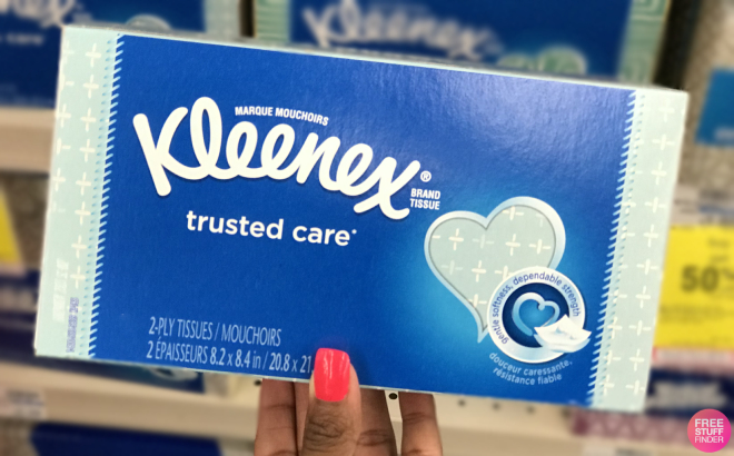 A Person Holding a Box of Kleenex Trusted Care Facial Tissues