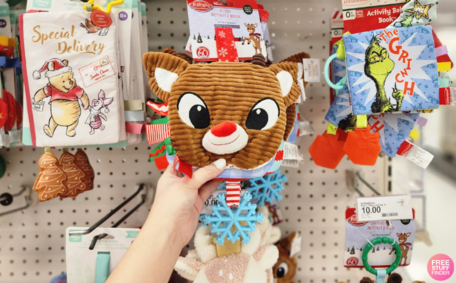 A Person Holding a Rudolph Plush Book with Teether