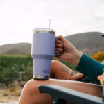 A Person Holding a YETI 35 Ounce Rambler Mug with Straw Lid