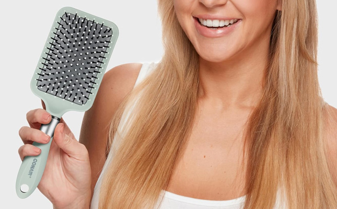 A Person Using Conair Velvet Touch Hair Brush