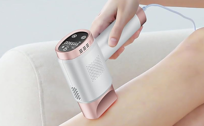 A Person Using the Aopvui Laser Hair Removal Device on the Leg