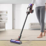 A Person Using the Dyson Digital Slim Cordless Stick Vacuum