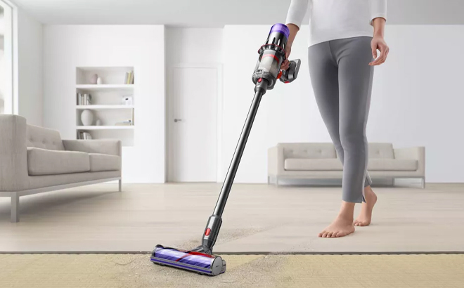 A Person Using the Dyson Digital Slim Cordless Stick Vacuum