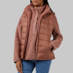 A Person Wearing 32 Degrees Womens Reversible Sherpa Lined Vest in Cognac Color