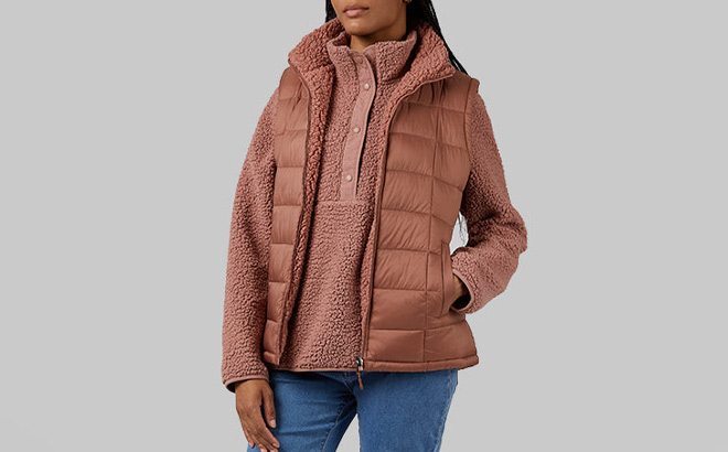 A Person Wearing 32 Degrees Womens Reversible Sherpa Lined Vest in Cognac Color