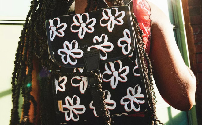 A Person Wearing Dr Martens Vegan Floral Scribble Mini Backpack