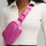 A Person Wearing Lululemon Everywhere Belt Bag in Pow Pink Tone