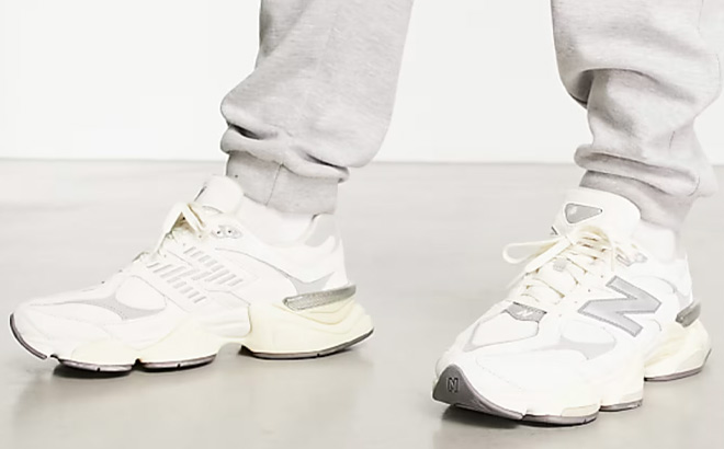 A Person Wearing New Balance 9060 Sneakers in White and Grey Metallic Color