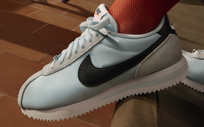 A Person Wearing Nike Cortez Womens Shoe