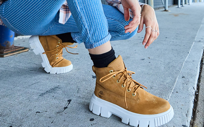 A Person Wearing Timberland Greyfield Boots in Wheat Color