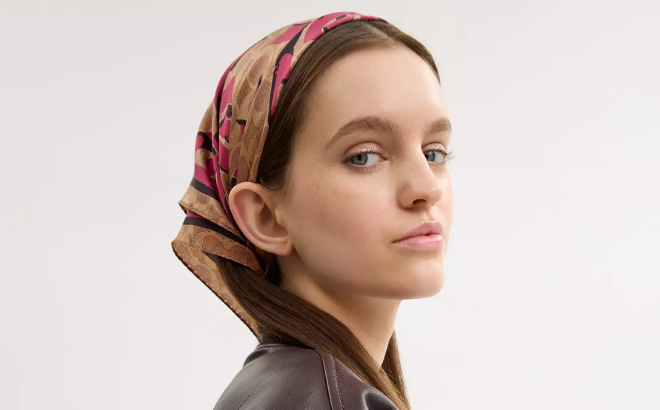 A Person Wearing a Coach Outlet Signature Bow Print Silk Bandana