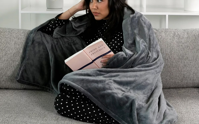 A Person Wearing the Brookstone Heated Cozy Throw in Grey