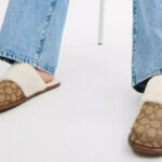 A Person Wearing the Coach Outlet Zena Slippers In Signature Jacquard