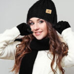 A Person Wearing the Winter Beanie Hat Scarf Gloves 3 Piece Winter Set in Black