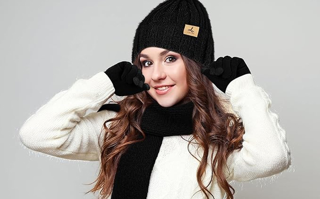 A Person Wearing the Winter Beanie Hat Scarf Gloves 3 Piece Winter Set in Black