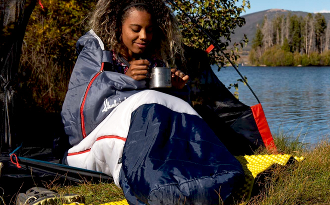 A Person sitting in a Slumberjack Mummy Fit Sleeping Bag