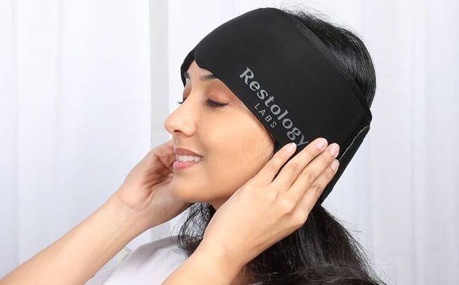 A Person wearing a Restology Labs Migraine Relief Cap