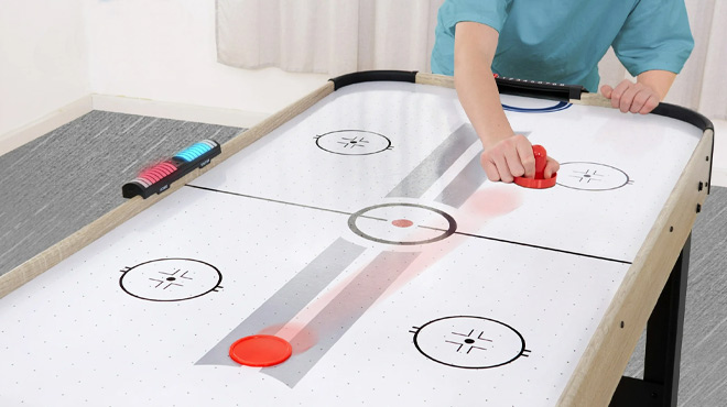 A Teenager Playing on the MD Sports 48 Inch Air Hockey Table