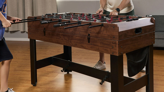 A Teenager and Man Playing on the MD Sports 54-Inch 4-in-1 Multi Game Table