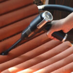 A Woman Cleaning a Chair with CasaClean 3 in 1 Handheld Multifunctional Vacuum Cleaner