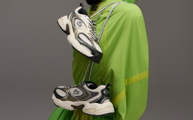 A Woman Holding Lacoste Storm 96 2K Sneakers