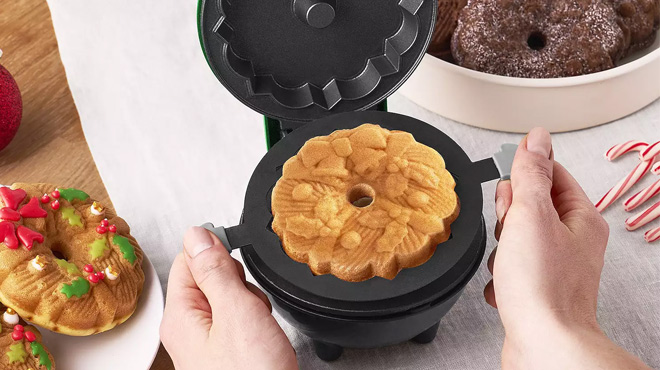 A Woman Holding the Dash Mini Wreath Bundt Maker